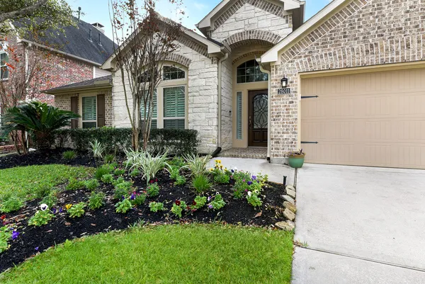 a front view of a house with a garden