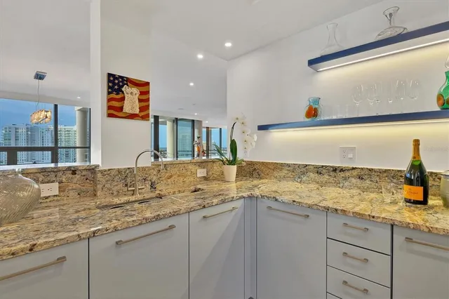 a kitchen with stainless steel appliances granite countertop a stove and a sink