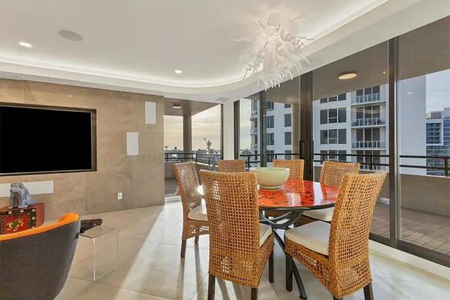 a bed sitting in a spacious bedroom next to a large window