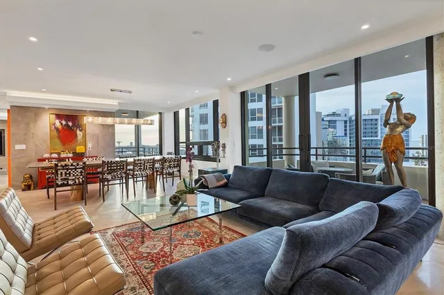 a room with stainless steel appliances kitchen island granite countertop a sink and cabinets