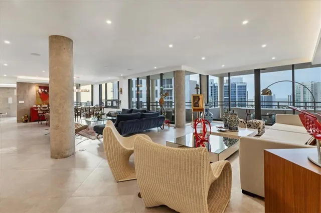 a living room with furniture and a floor to ceiling window