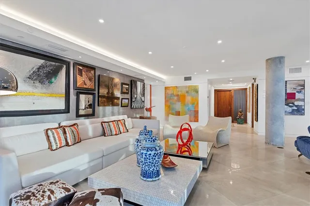 a living room with furniture and dining room