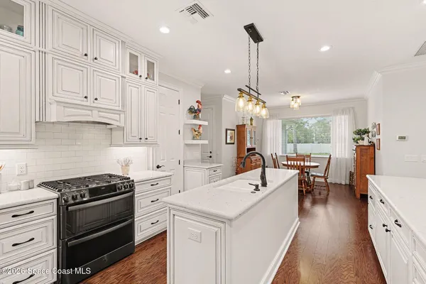 a dining room with furniture and wooden floor
