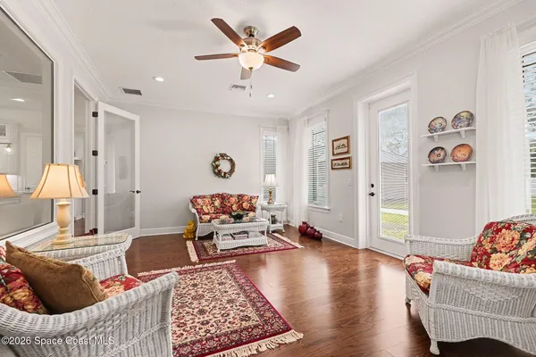 a room with furniture and view of kitchen