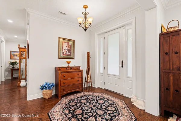 a living room with furniture a rug and a chandelier