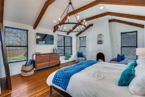 a bedroom with a bed and a flat screen tv