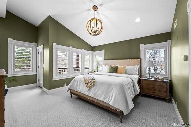 a spacious bedroom with a bed and a window