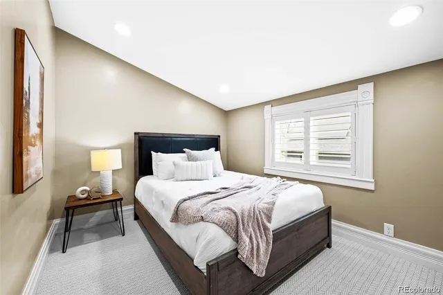 a bedroom with a bed and a night stand