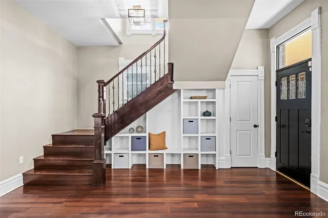a view of entryway and hall with wooden floor