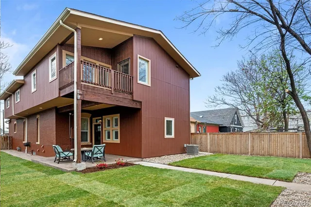 a view of a house with a yard and sitting area