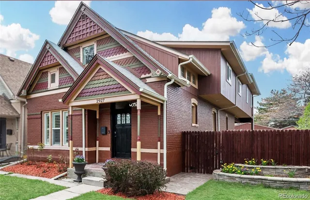 a front view of house with a garden