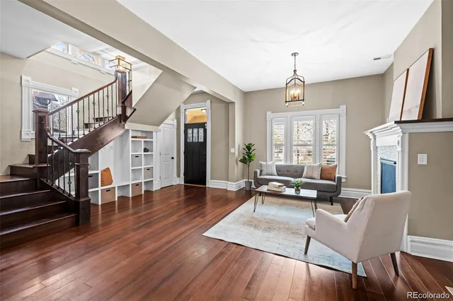a living room with furniture windows and wooden floor