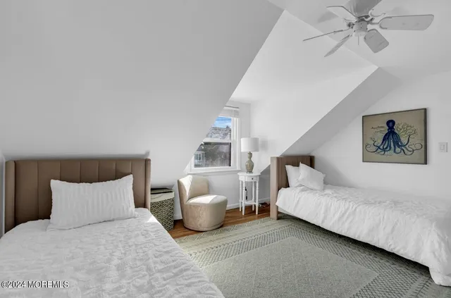 a bedroom with bed and a chandelier