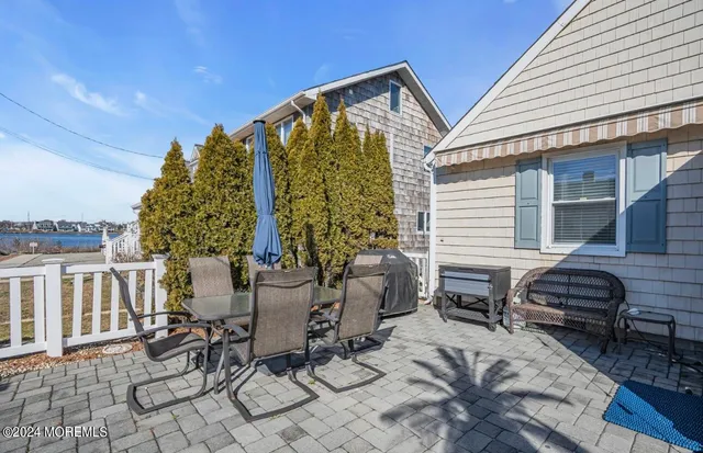 a view of a patio with couches table and chairs and potted plants