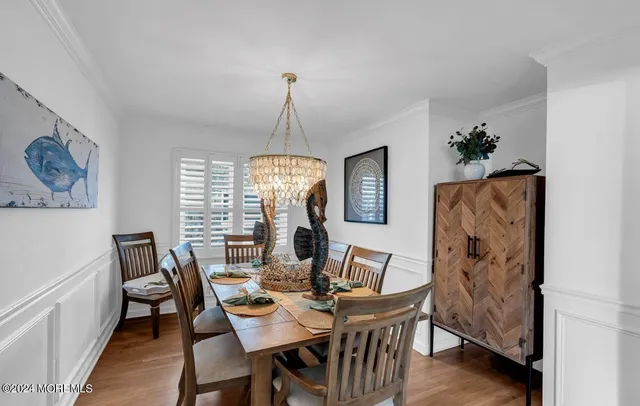 a view of a dining room with furniture wooden floor and chandelier