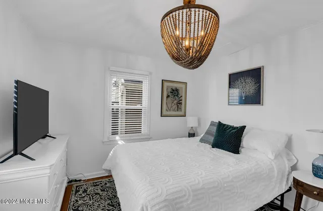 a bedroom with a bed and a television