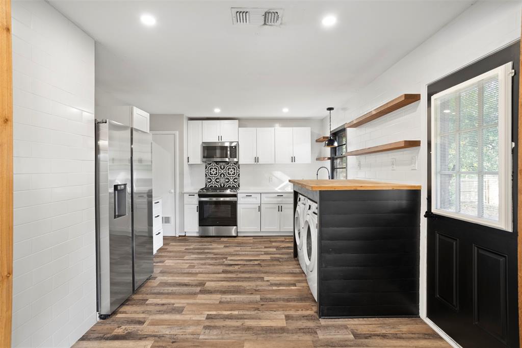 611 East Watkins Street Tyler, TX 75701 - Photo 12 of 29 a kitchen with stainless steel appliances kitchen island granite countertop a refrigerator and a sink