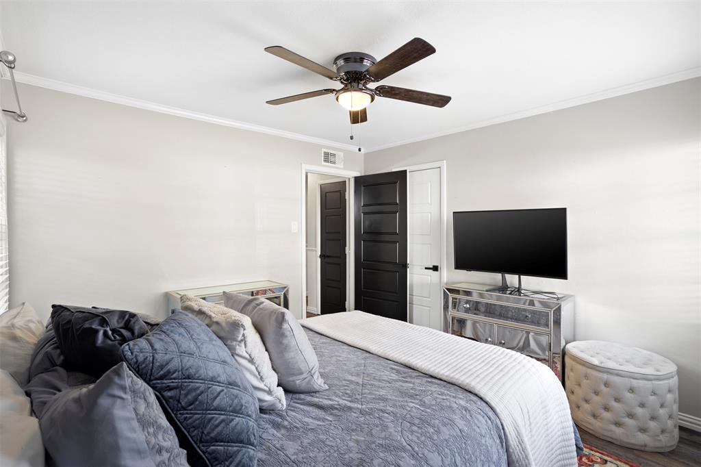 611 East Watkins Street Tyler, TX 75701 - Photo 21 of 29 a bedroom with a bed and a flat screen tv