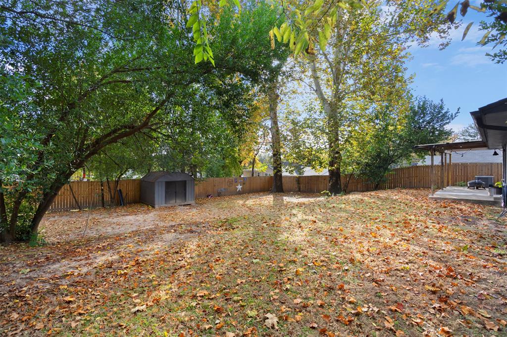 611 East Watkins Street Tyler, TX 75701 - Photo 27 of 29 a backyard of a house with a tree