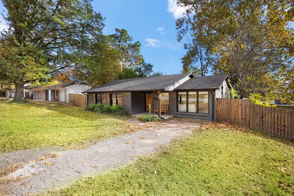 611 East Watkins Street Tyler, TX 75701 - Photo 28 of 29 a front view of a house with a garden and trees