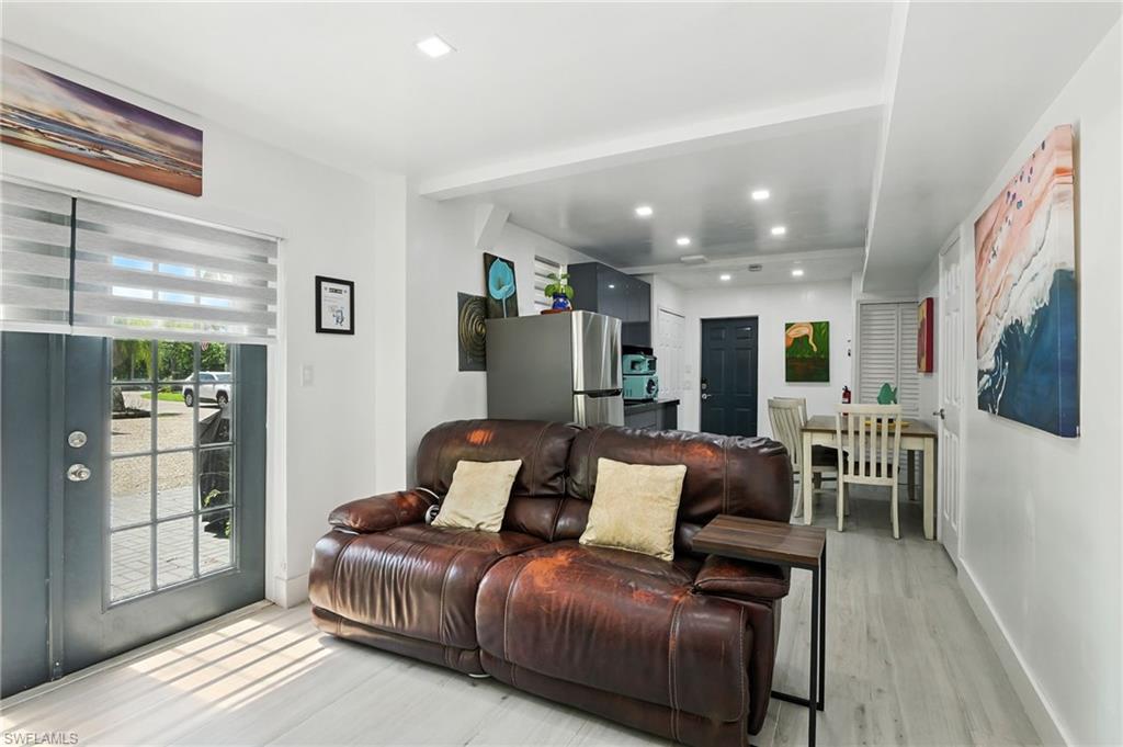 936 Panther Creek Lane Everglades City, FL 34139 - Photo 10 of 50 a living room with furniture a flat screen tv and a floor to ceiling window