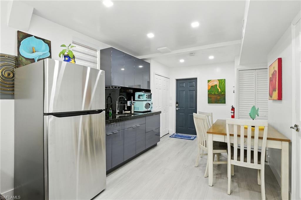 936 Panther Creek Lane Everglades City, FL 34139 - Photo 11 of 50 a kitchen with stainless steel appliances a refrigerator and a dining table