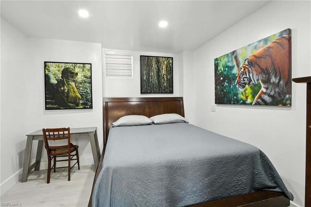 936 Panther Creek Lane Everglades City, FL 34139 - Photo 15 of 50 a bedroom with a bed and wooden floor