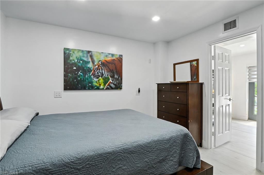 936 Panther Creek Lane Everglades City, FL 34139 - Photo 16 of 50 a bedroom with a bed and a cabinets