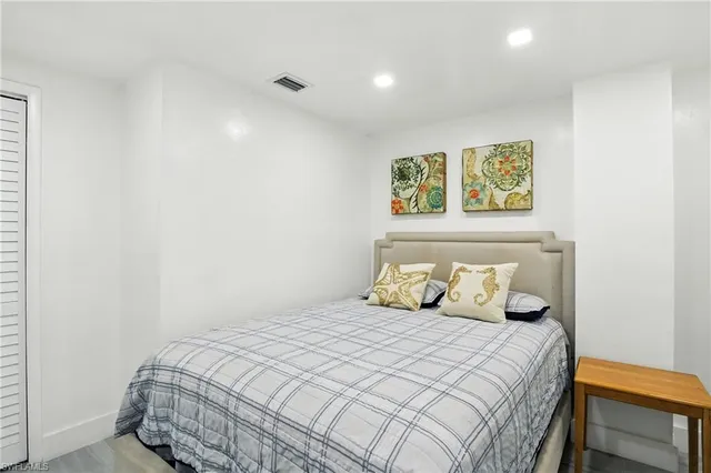 a kitchen with stainless steel appliances granite countertop a dining table and chairs