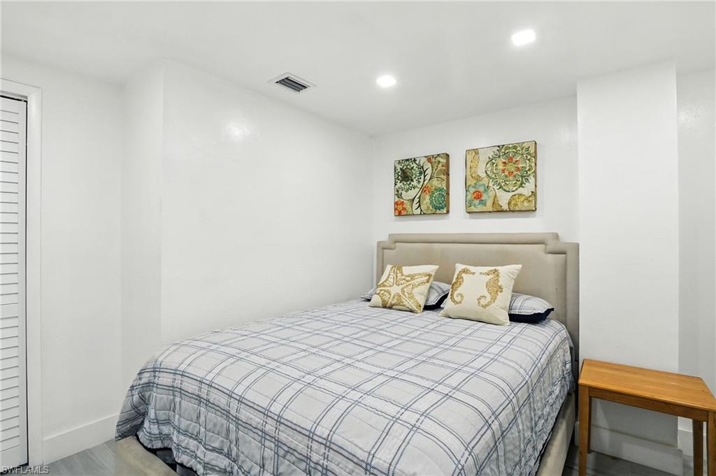 936 Panther Creek Lane Everglades City, FL 34139 - Photo 21 of 50 a bedroom with a bed and painting on the wall