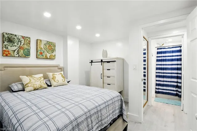 a bedroom with a bed and painting on the wall