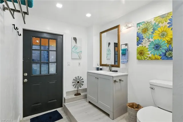 a bedroom with a bed and painting on the wall