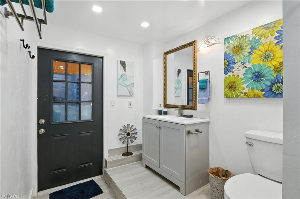936 Panther Creek Lane Everglades City, FL 34139 - Photo 23 of 50 a bathroom with a toilet sink and mirror
