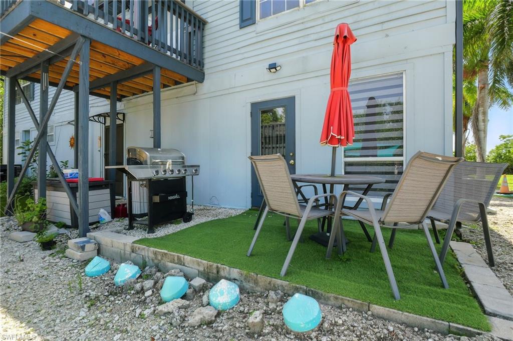 936 Panther Creek Lane Everglades City, FL 34139 - Photo 24 of 50 a view of backyard with table and chairs and potted plants