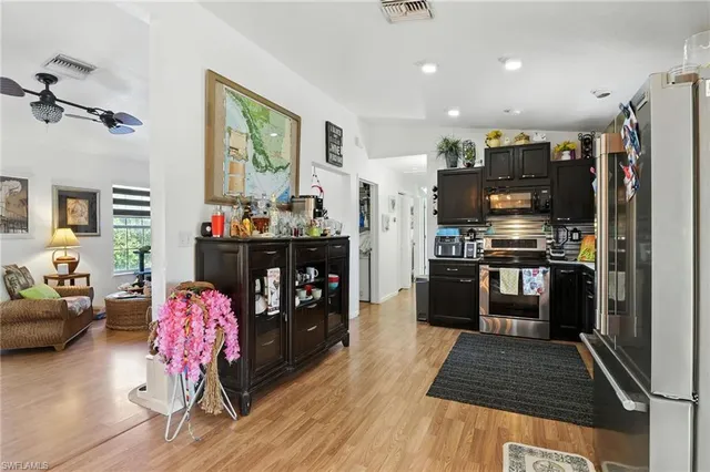 a kitchen with stainless steel appliances granite countertop a refrigerator and a stove top oven