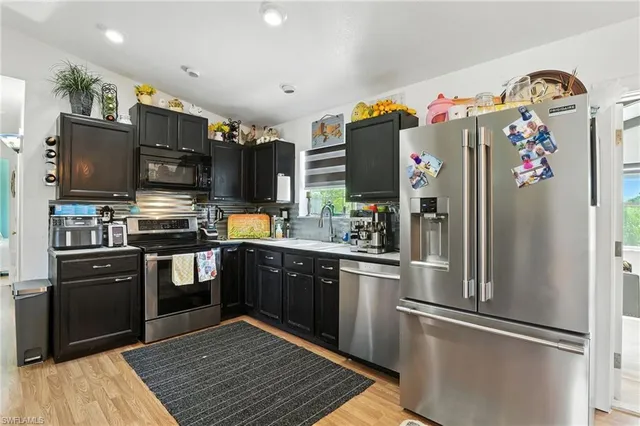 a living room with furniture kitchen view and a window
