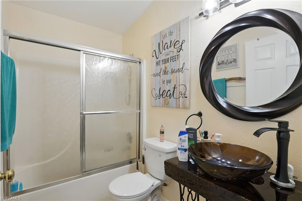 936 Panther Creek Lane Everglades City, FL 34139 - Photo 38 of 50 a bathroom with a toilet a sink and a mirror