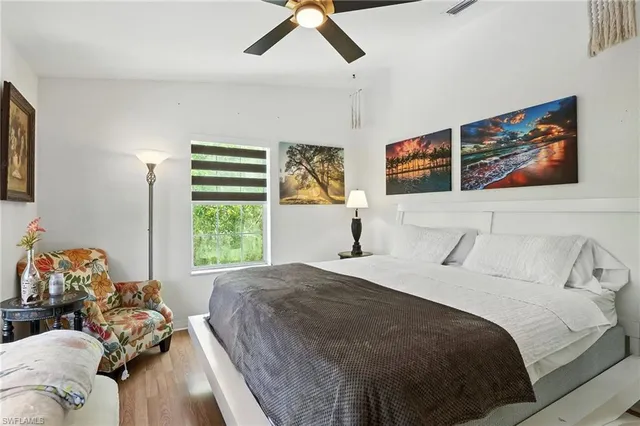 a bedroom with a large bed and a large window