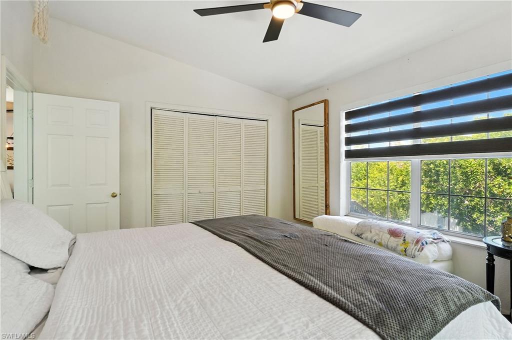 936 Panther Creek Lane Everglades City, FL 34139 - Photo 42 of 50 a bedroom with a large bed and a large window