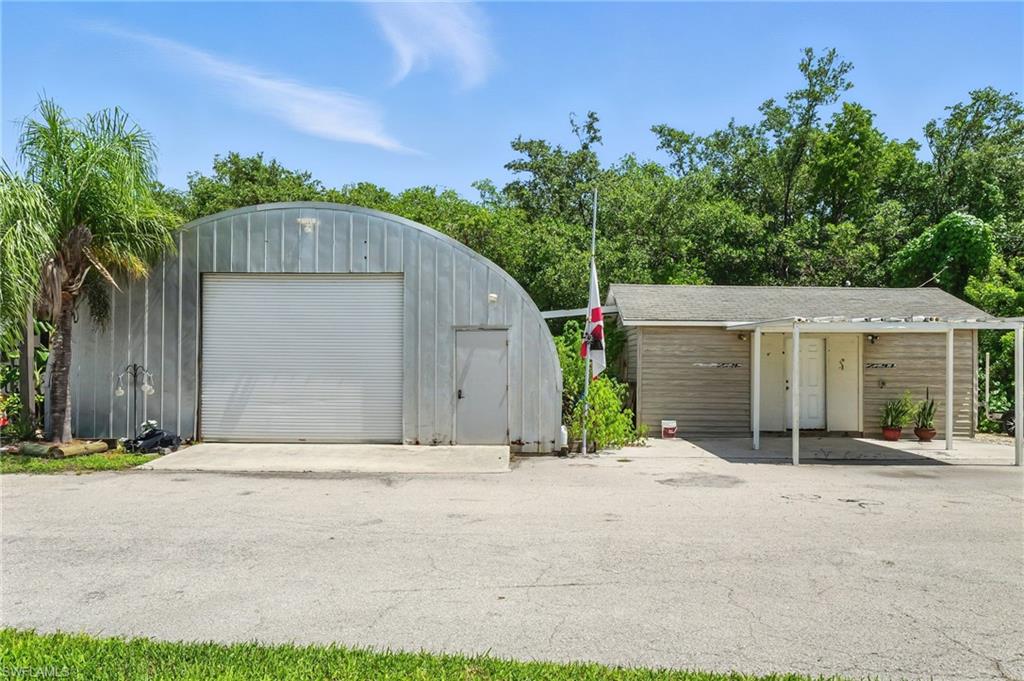 936 Panther Creek Lane Everglades City, FL 34139 - Photo 48 of 50 a front view of a house with a yard and a garage