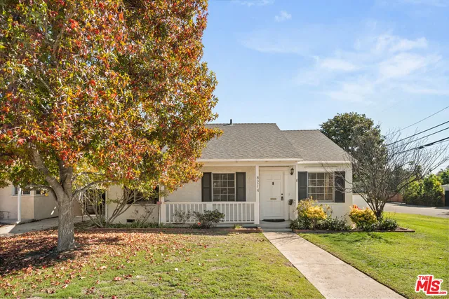 a front view of a house with a garden and yard
