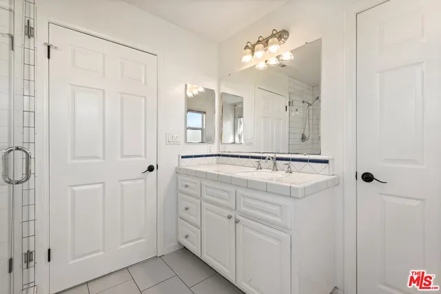 a bathroom with a double vanity sink and a mirror