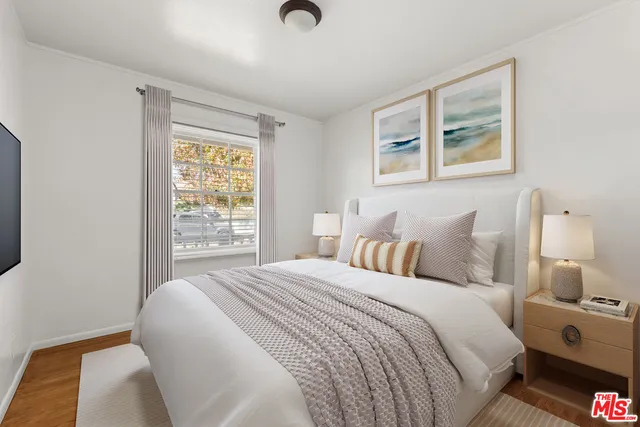 a bedroom with bed and a night stand