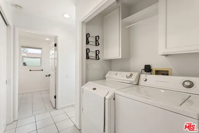 a view of washer and dryer with kitchen in the background