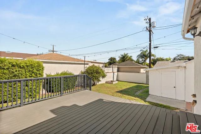 a view of a balcony with wooden floor