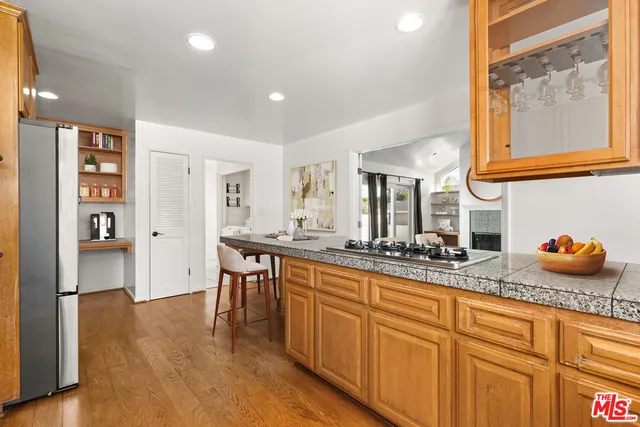 a kitchen with sink and refrigerator