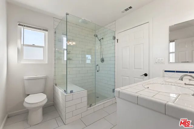 a bathroom with a toilet sink and shower