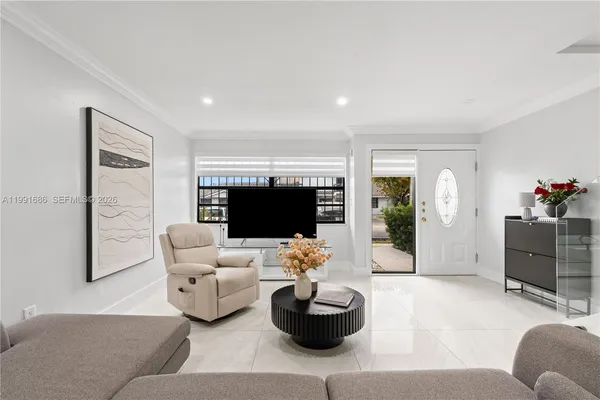 a living room with furniture and a flat screen tv