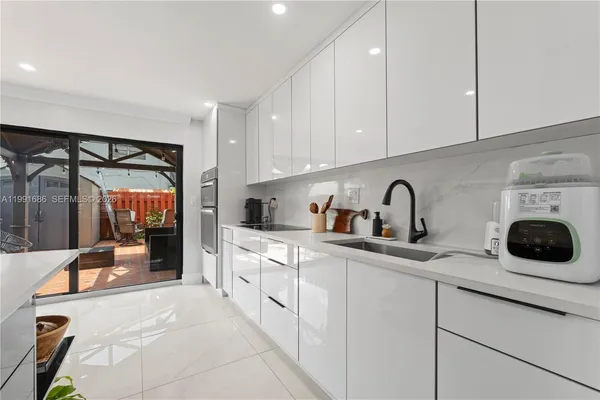 a kitchen with stainless steel appliances granite countertop a refrigerator sink and cabinets