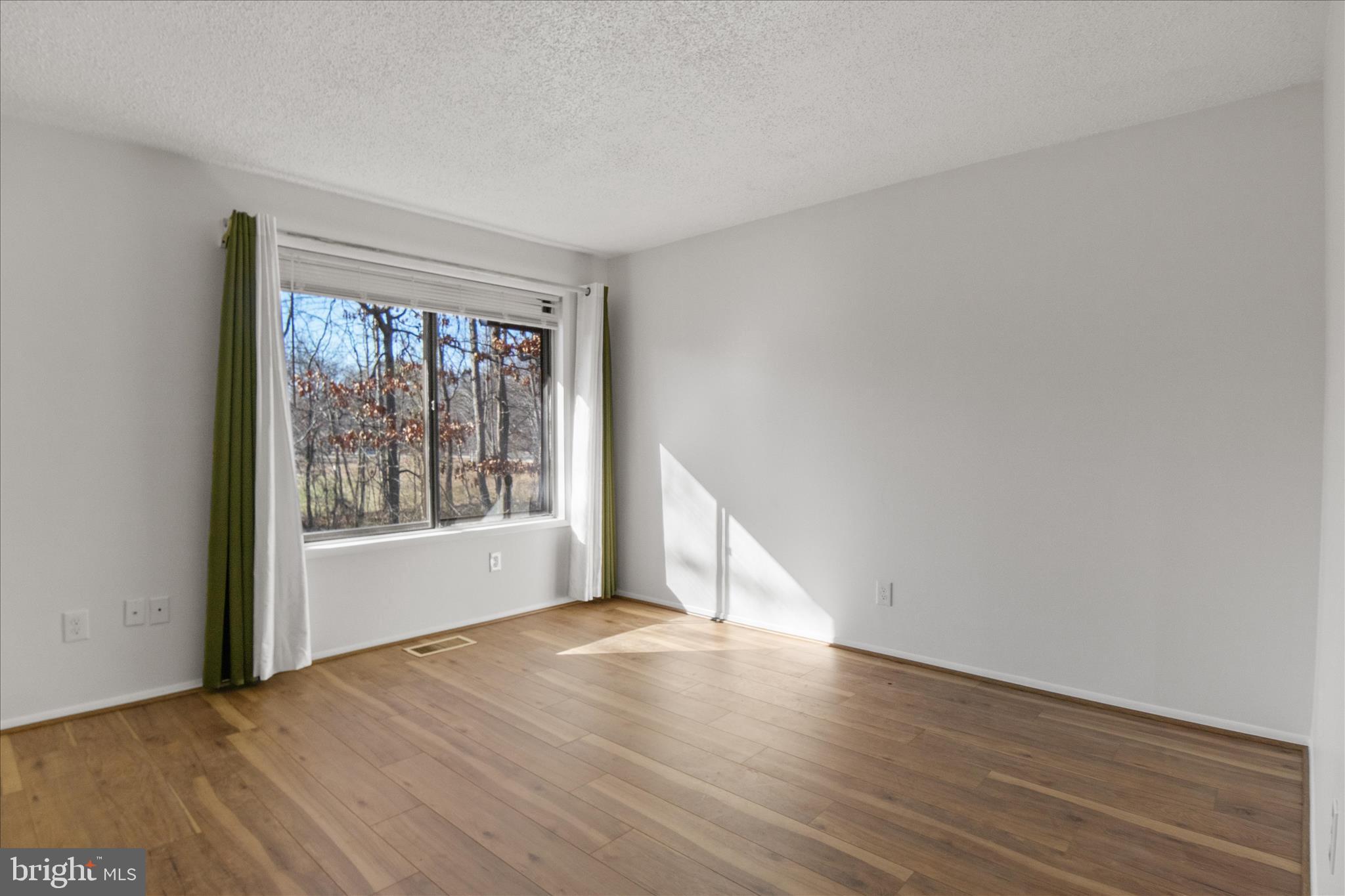 2142 Cartwright Place Reston, VA 20191 - Photo 12 of 29 a view of an empty room with wooden floor and a window